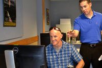 two men looking at computer screen